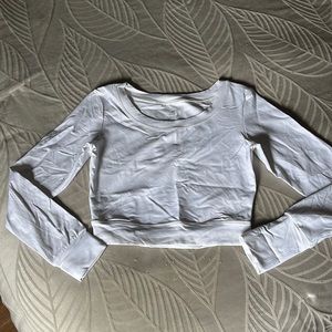 NVGTN long sleeve crop top with OPEN back bottom center of back.